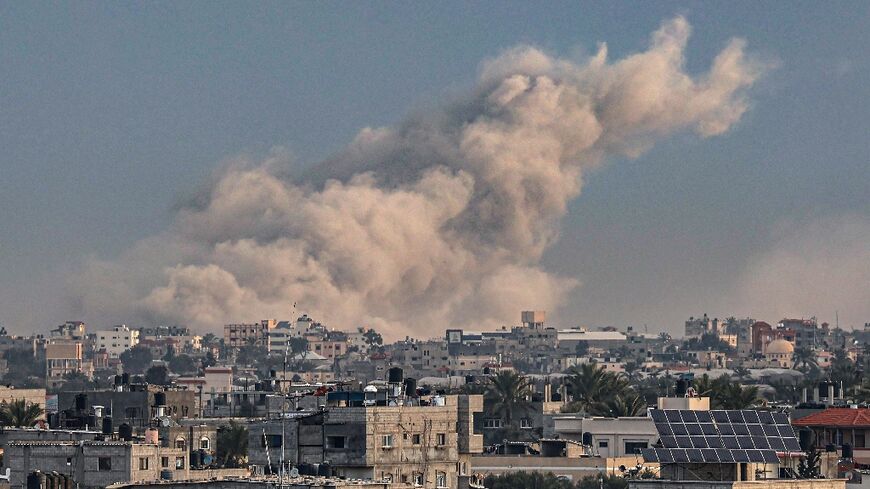 Smoke billowing over Khan Yunis in the southern Gaza Strip during Israeli bombardment