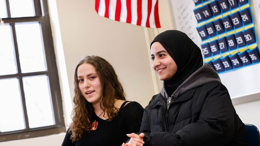 Rawda Elbatrawish (R) and Liora Pelavin speak during an interview at Teaneck High School in Teaneck, New Jersey, a city with large Jewish and Muslim populations that was shaken by the attacks of October 7