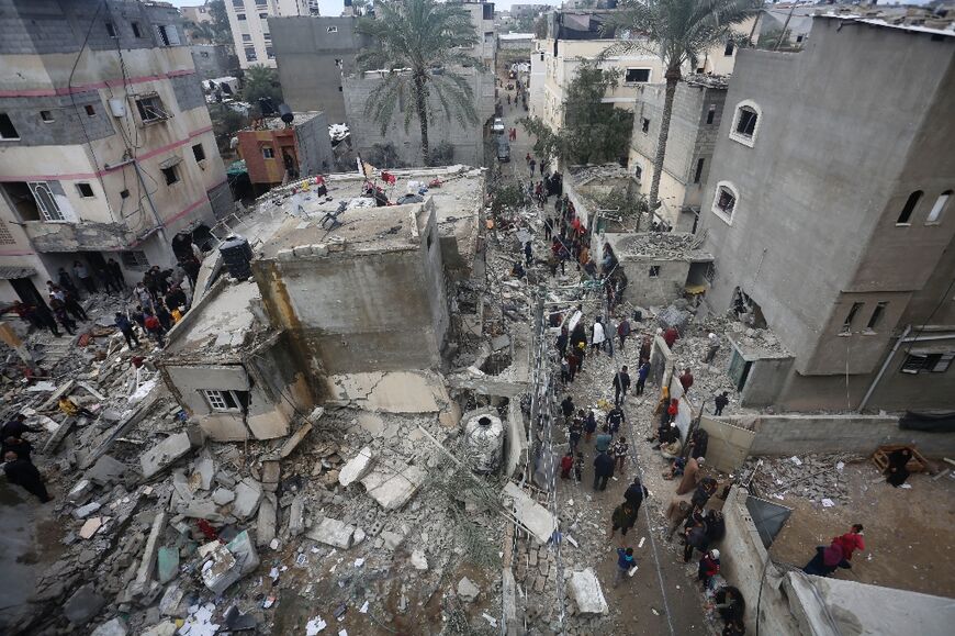 People search for victims in the rubble of the Baraka family home in Deir al-Balah in the central Gaza Strip after it was hit in an Israeli air strike