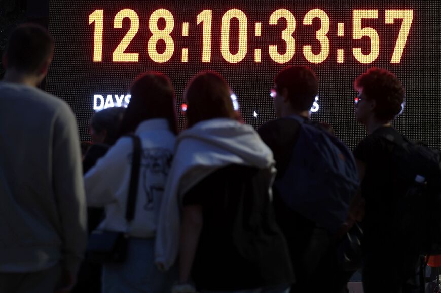 Relatives and supporters of Israeli hostages held in Gaza look at a screen showing showing the days, hours, minutes and seconds since the October 7 attack